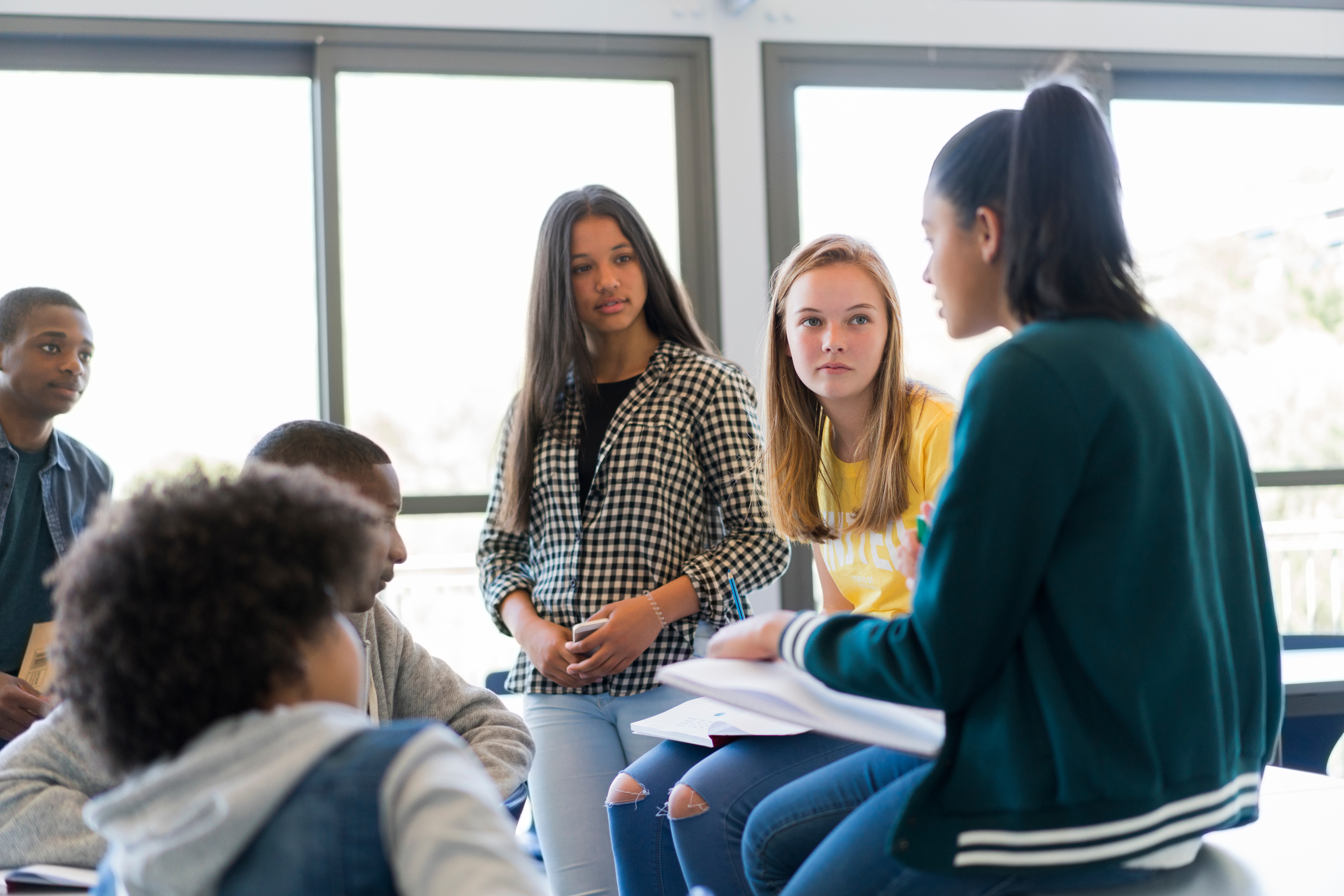 Multi-ethnic students discussing in classroom