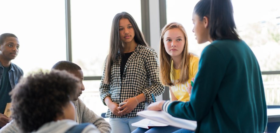 Multi-ethnic students discussing in classroom