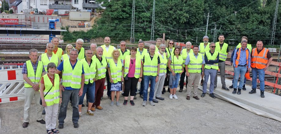 Eine Gruppe von Menschen in gelben Warnwesten auf einer Baustelle