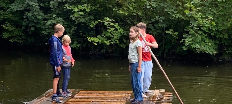 Vier Kinder auf einem Floß